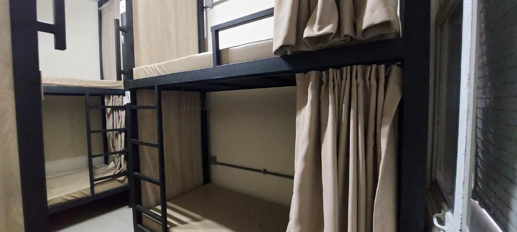 a bunk bed in a room with a curtain at Hostel Leblon in Rio de Janeiro