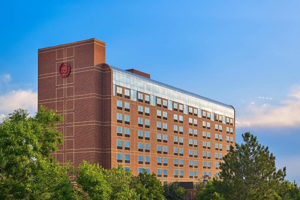 a tall brick building with a clock on it at Sheraton Hotel Denver Tech Center in Greenwood Village