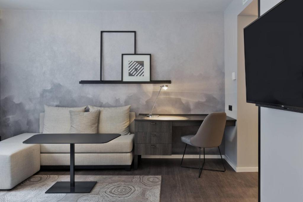 a living room with a couch and a table at Residence Inn by Marriott Frankfurt City Center in Frankfurt