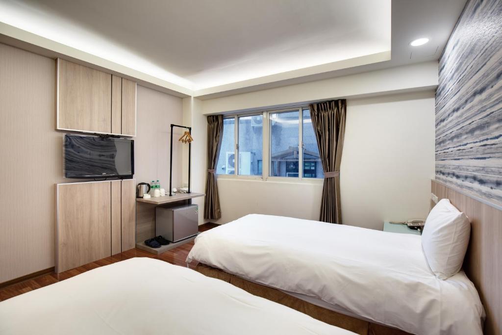Postel nebo postele na pokoji v ubytování 天璽商務飯店 Cullinan Hotel