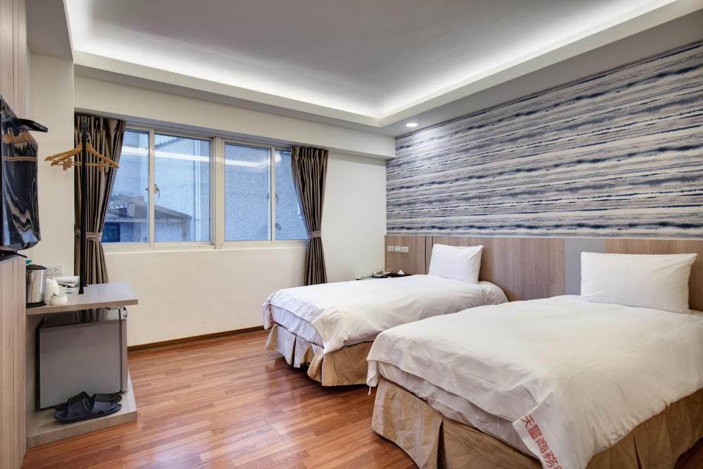 Postel nebo postele na pokoji v ubytování 天璽商務飯店 Cullinan Hotel