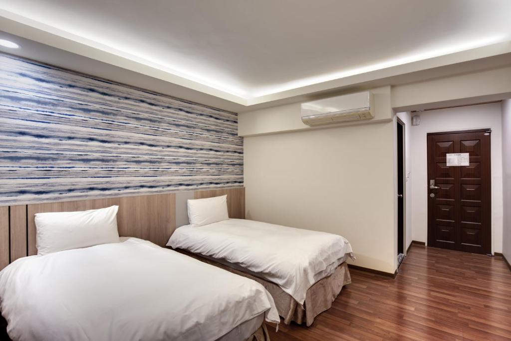 Postel nebo postele na pokoji v ubytování 天璽商務飯店 Cullinan Hotel