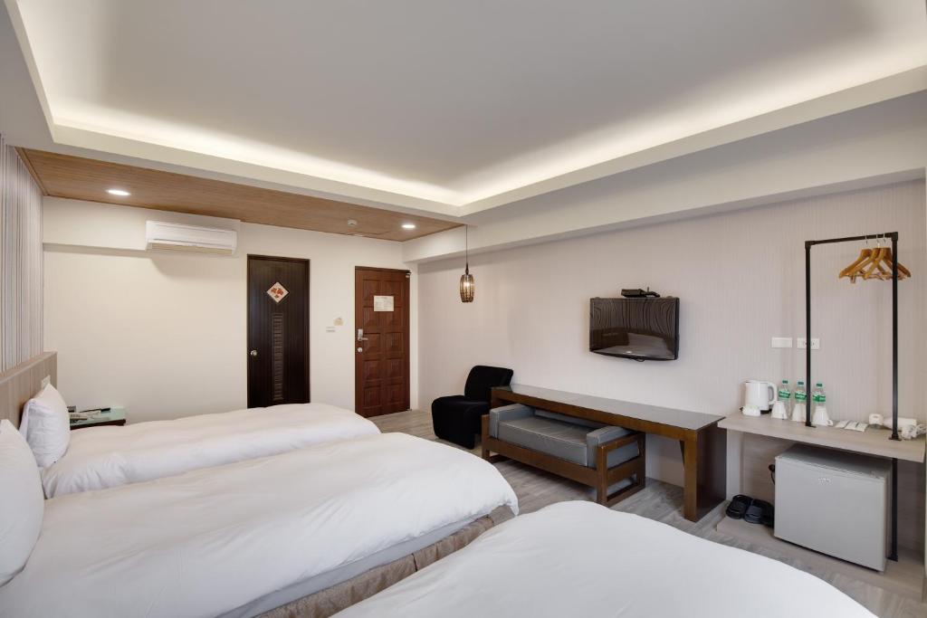 Postel nebo postele na pokoji v ubytování 天璽商務飯店 Cullinan Hotel