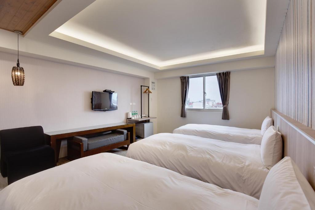 Postel nebo postele na pokoji v ubytování 天璽商務飯店 Cullinan Hotel