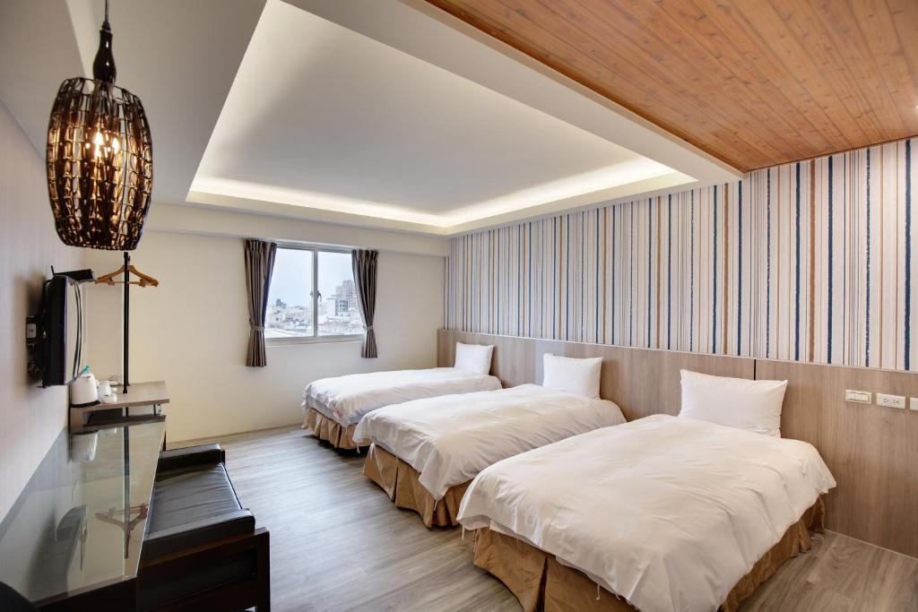 Postel nebo postele na pokoji v ubytování 天璽商務飯店 Cullinan Hotel