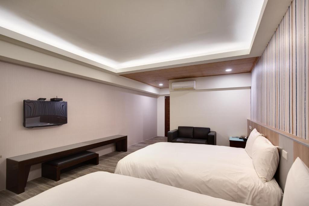 Postel nebo postele na pokoji v ubytování 天璽商務飯店 Cullinan Hotel
