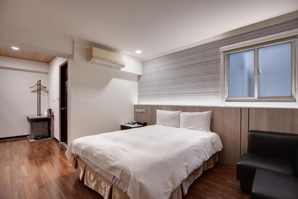 Postel nebo postele na pokoji v ubytování 天璽商務飯店 Cullinan Hotel