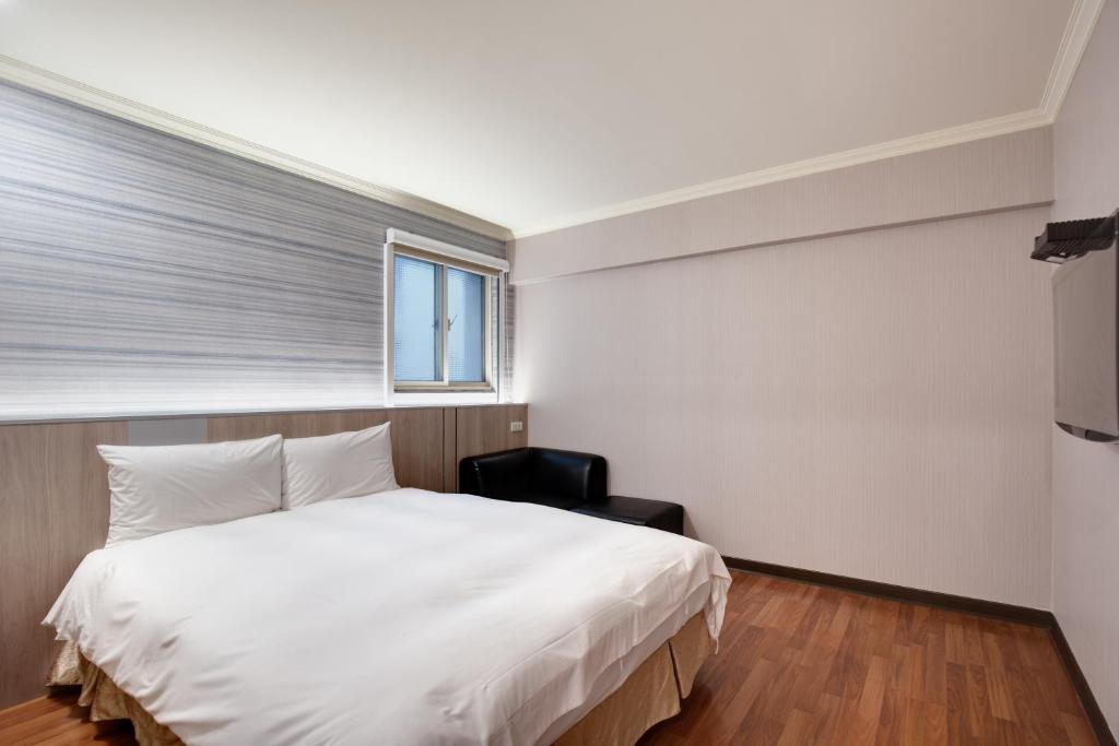Postel nebo postele na pokoji v ubytování 天璽商務飯店 Cullinan Hotel