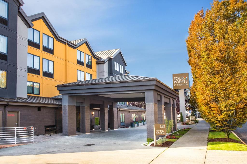 a building with a garage in front of a street at Four Points by Sheraton Downtown Seattle Center in Seattle