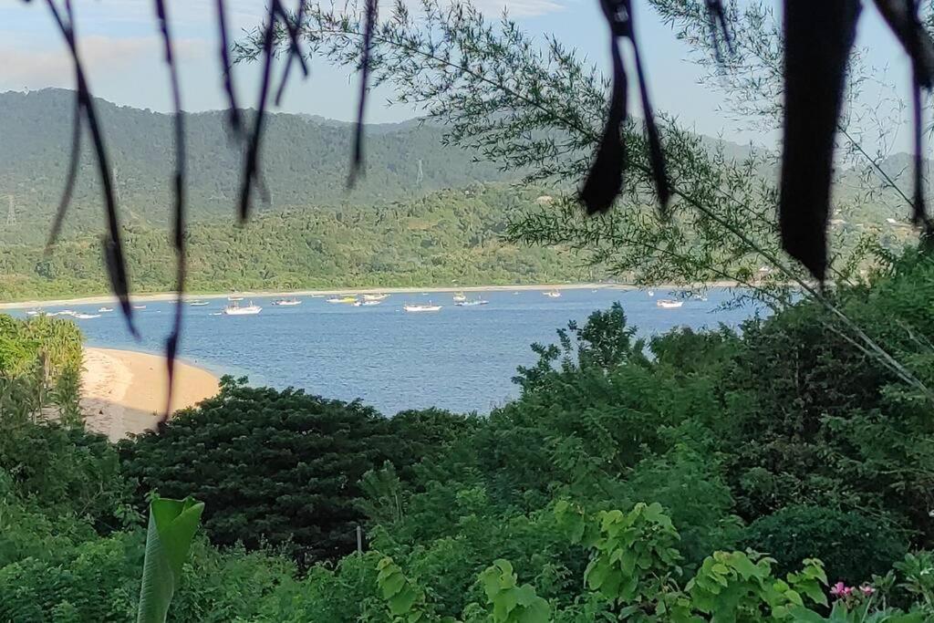 a view of a beach with boats in the water at Bamboo hut Alpha Hotel in Maluk