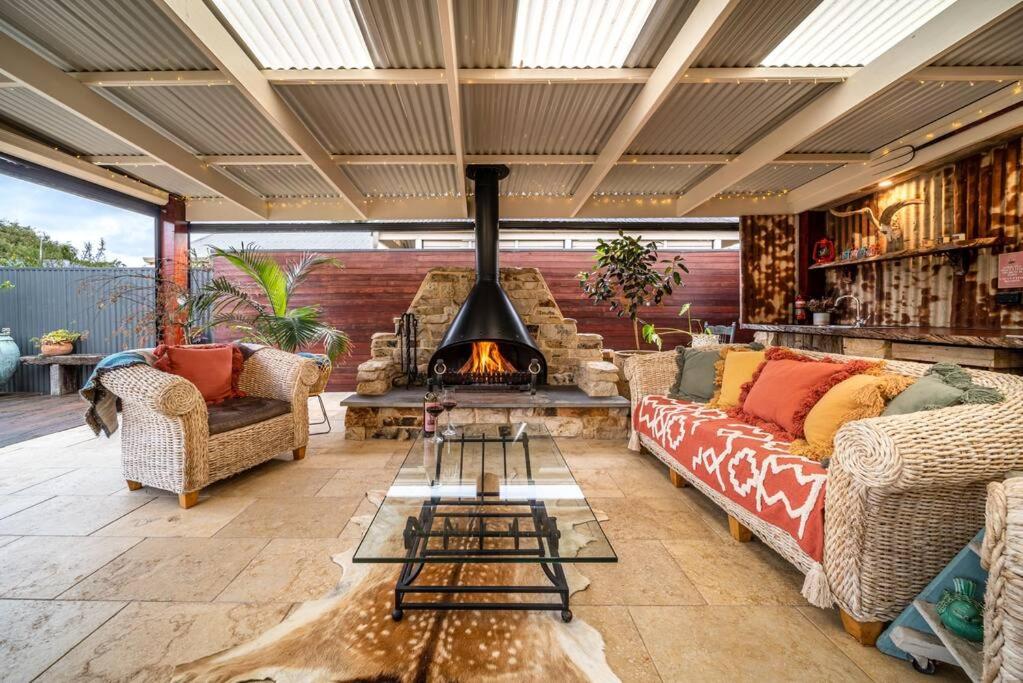 a living room with a couch and a fireplace at Laurant's Cottage ~ McLaren Vale entertainer in McLaren Vale