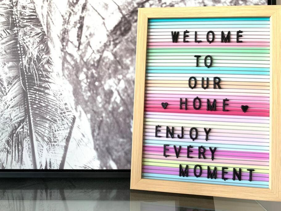 a picture of a sign that says welcome to our home enjoy every woman at City View Luxury 3 Bedroom Apartment-Free Car Park in Melbourne