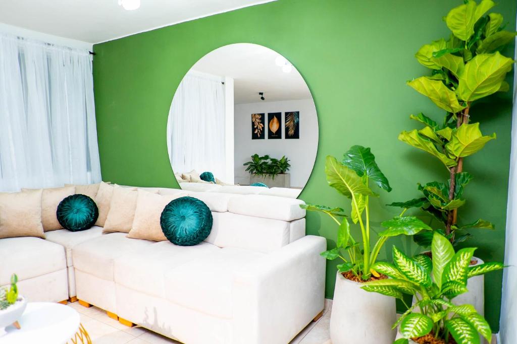 sala de estar con sofá blanco y espejo en Casa Meraki, en Medellín