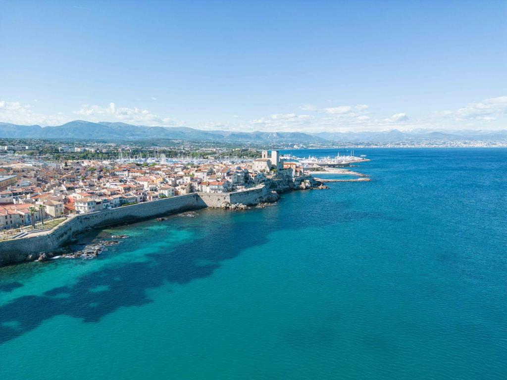 an aerial view of a city on the water at Hôtel Beau Site - Cap d'Antibes in Antibes