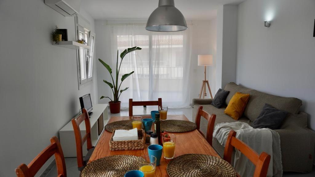 a living room with a table with chairs and a couch at Viviendas Margarita II in Colònia de Sant Jordi