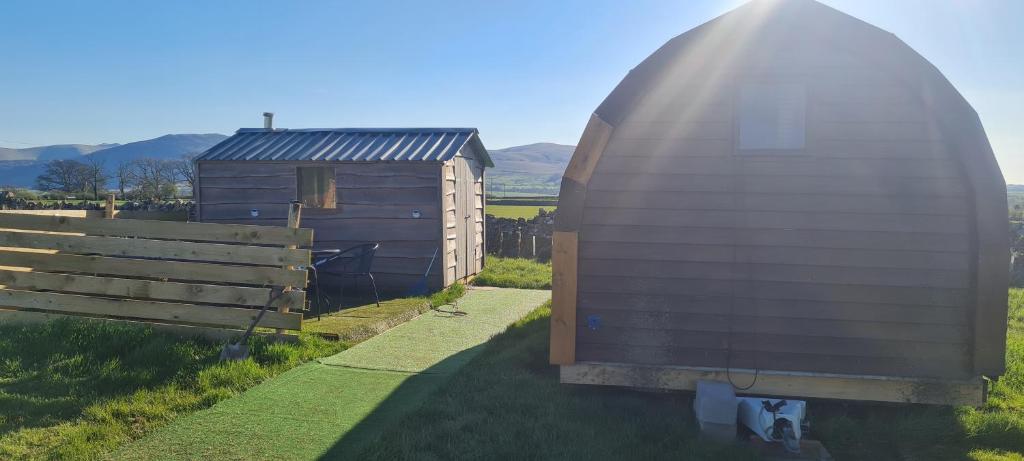 a barn with a dome next to a house at Cherry Trees Farm Campsite in Welton