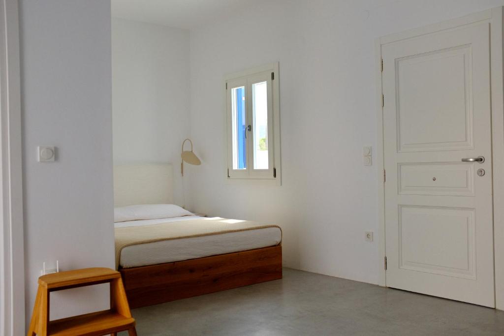 a bedroom with a bed and a window and a door at MILORA SuNSET in Pollonia