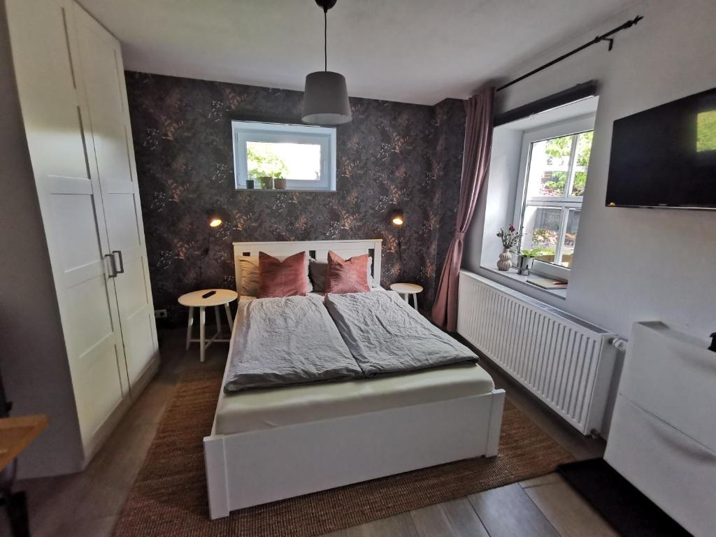 a small bedroom with a bed and a window at Apartment Maiglöckchen in Fritzlar
