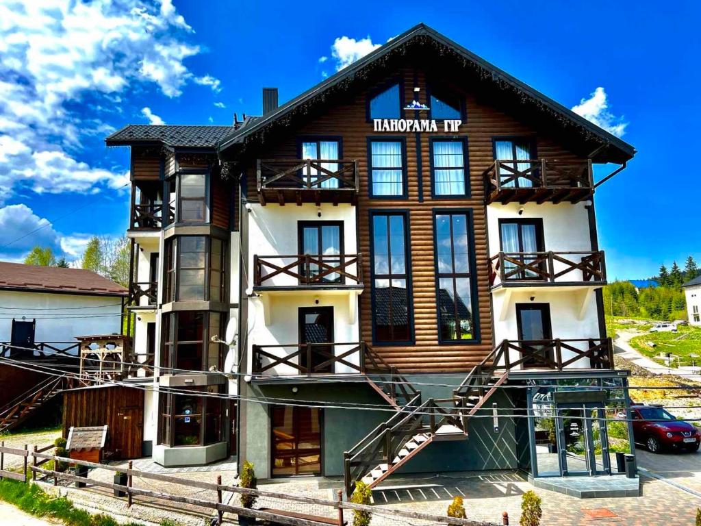 a large building with a staircase in front of it at Панорама гір in Bukovel