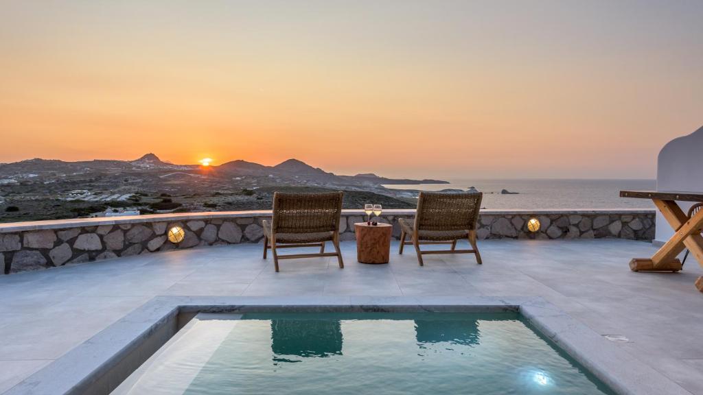 a view of the ocean from a villa with a pool at Thea Sunset Suites in Mytakas