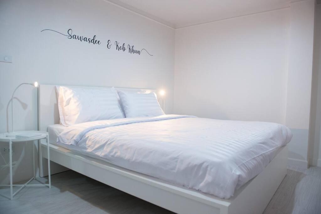 1 dormitorio blanco con 1 cama con una señal encima en Room 4 Bangkok Center WIFI Netflix, en Bangkok