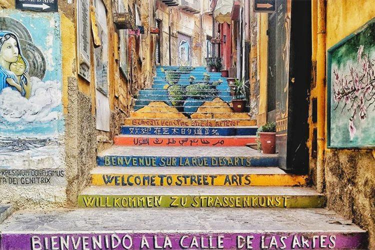 a painting of a stairway with paintings on it at Sicilia bedda in Agrigento