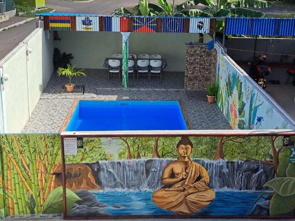a swimming pool with a painting of a buddha at Villa Elyza in Rodrigues Island