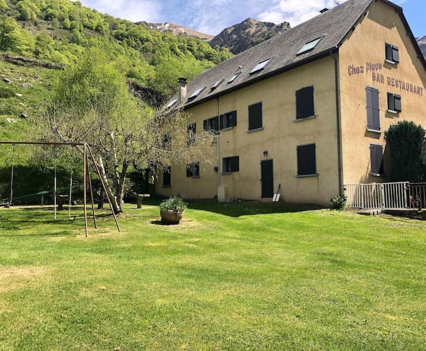 a building with a large yard with a playground at Appartement Chez Place à Estaing in Estaing