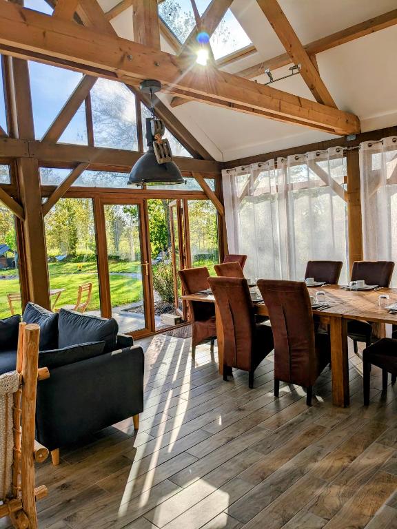a dining room with a table and chairs at Chambres d'hôtes chez l'habitant - Bed & Breakfast homestay in Huisnes-sur-Mer