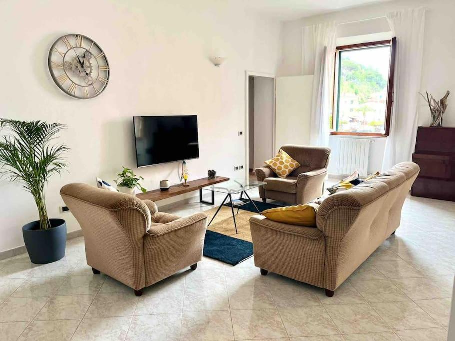 a living room with two chairs and a flat screen tv at A Casa di Nonna Anna in Porto Azzurro