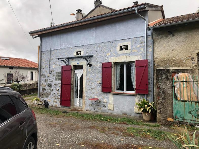 ein altes Steinhaus mit roten Rollläden darauf in der Unterkunft Barbazan comminges in Barbazan