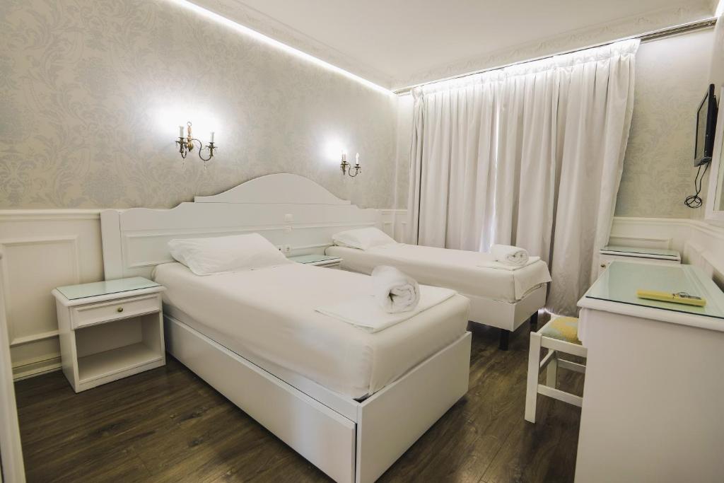 Postel nebo postele na pokoji v ubytování Porto Eda Hotel