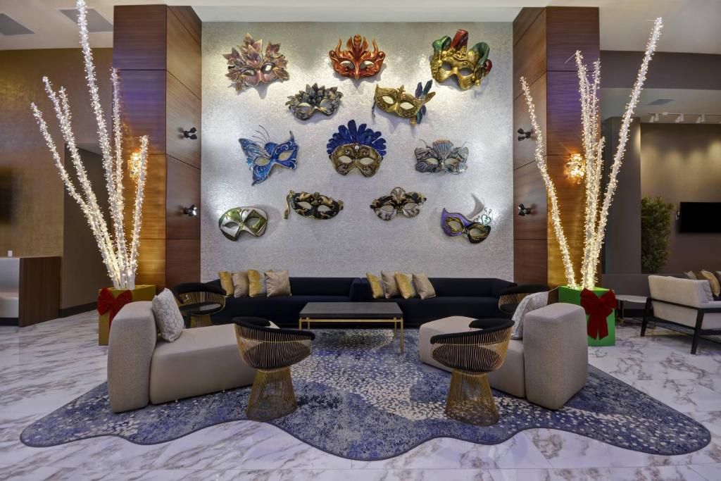 a lobby with couches and masks on the wall at Residence Inn by Marriott New Orleans French Quarter Area/Cen B in New Orleans