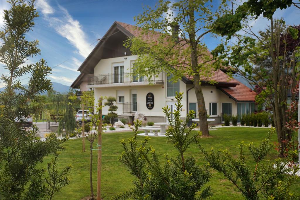 a white house with a yard at 47 Heaven Luxury House in Radovljica