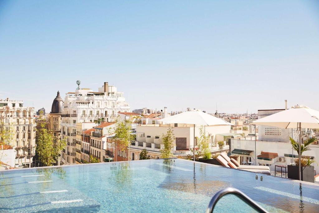 a swimming pool on the roof of a building at Thompson Madrid, by Hyatt in Madrid