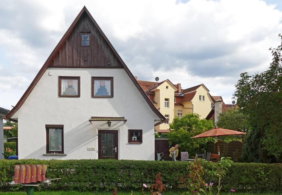 a large white house with a gambrel roof at Das Meininger Ferienhaus in Meiningen