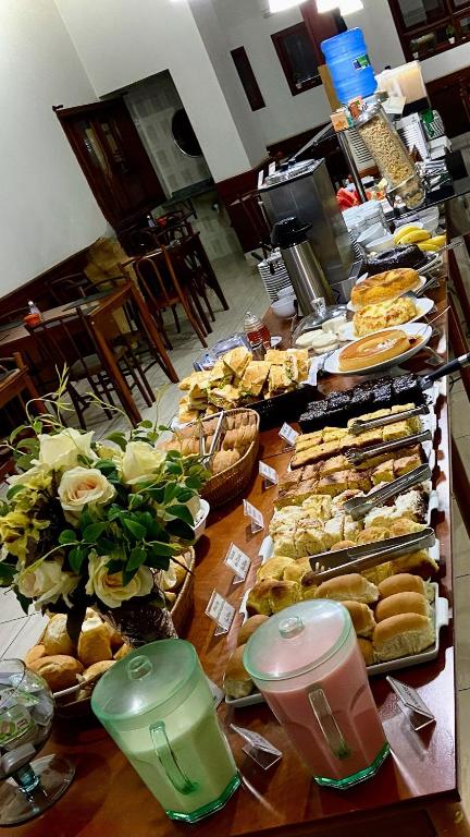 a buffet of sandwiches and other food on a table at Hotel Garrafão - Rua Principal de Boituva in Boituva