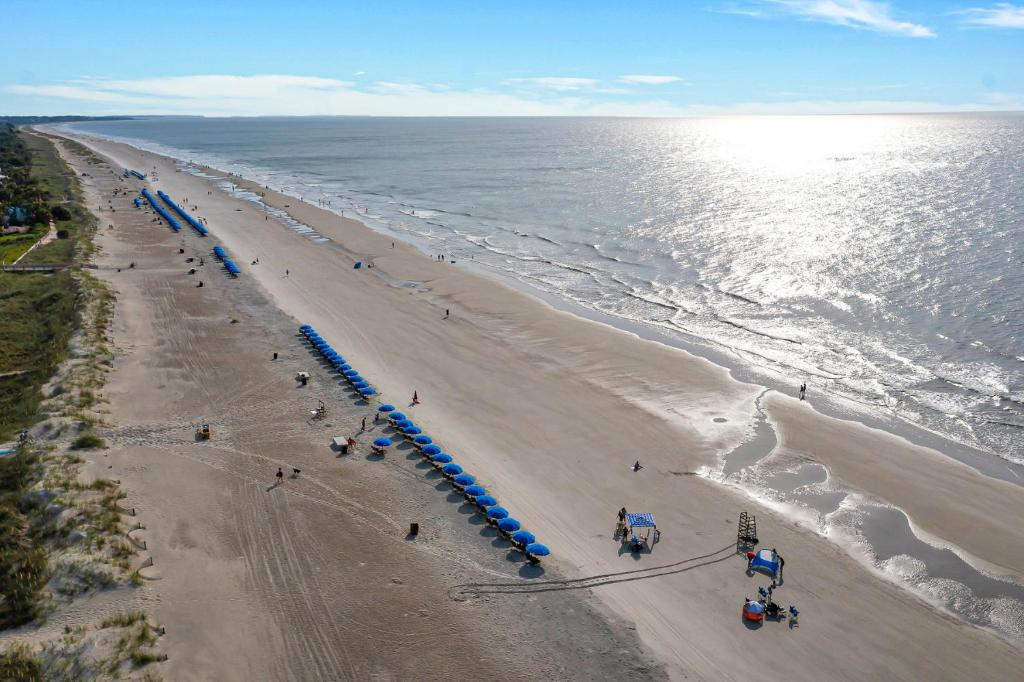 an overhead view of a beach with people and umbrellas at 672 Queens Grant in Hilton Head Island