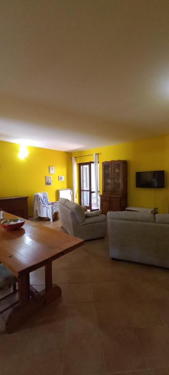 a living room with couches and a table in a room at Casa tamara in Sezze