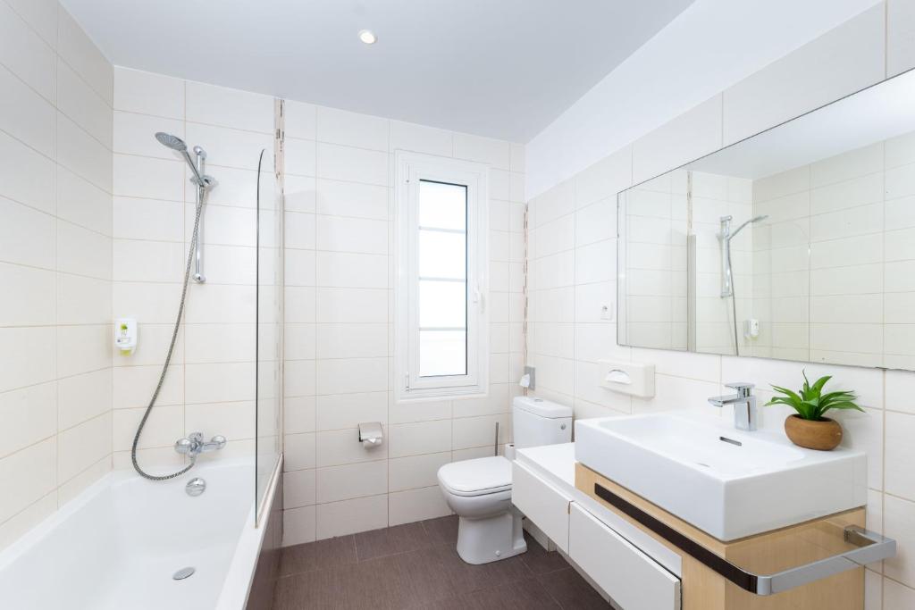a bathroom with a sink and a toilet and a shower at Hôtel Beau Site - Cap d'Antibes in Antibes