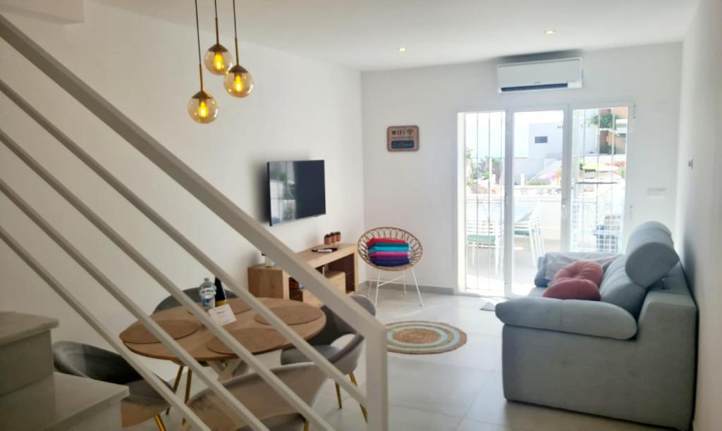 a living room with a staircase and a couch at Casa-Mar Nerja in Nerja