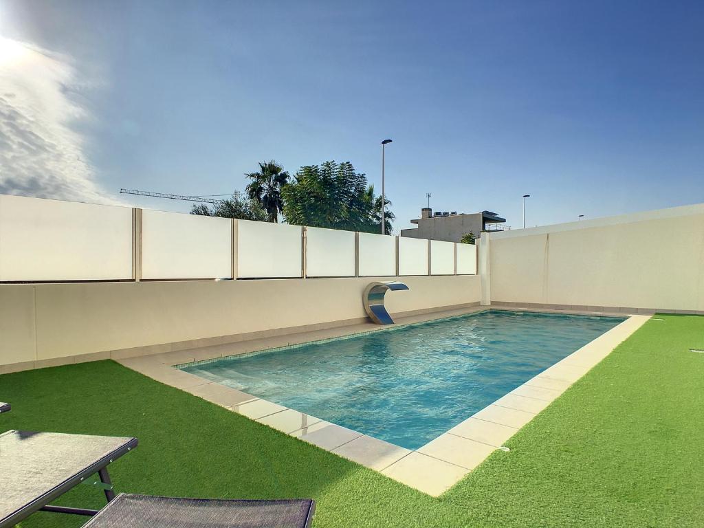 a swimming pool on the side of a building at Levansur Apartment - 9109 in San Pedro del Pinatar