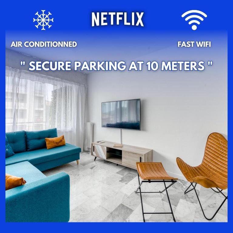 un salon avec un canapé bleu et une télévision dans l'établissement 4P Modern & Secured Parking, au Cannet