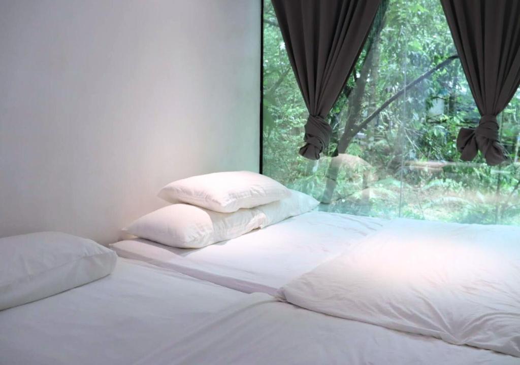 Voodi või voodid majutusasutuse Time Capsule Retreat, Sungai Lembing toas