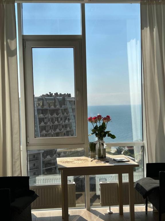 a table in a room with a view of the ocean at Apartments Arcadia VIP in Odesa