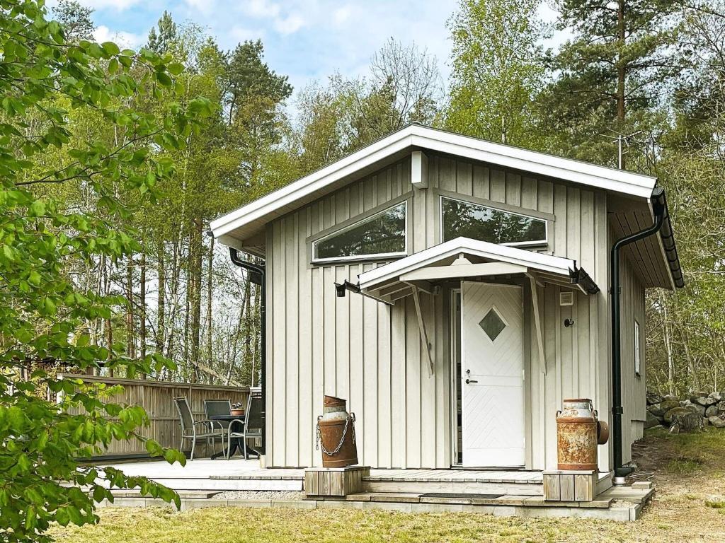 małą szopę z białymi drzwiami na dziedzińcu w obiekcie Holiday home SÖLVESBORG XVI w mieście Sölvesborg