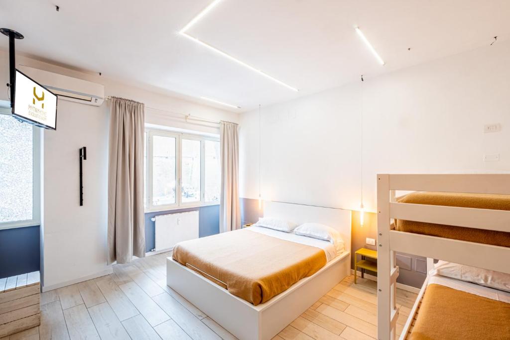 a bedroom with a bed and two bunk beds at My Tiny Home in Rome
