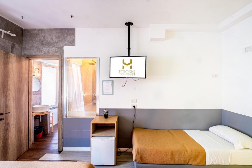 a bedroom with a bed and a pendant light at My Tiny Home in Rome