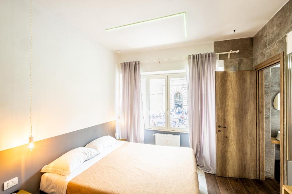 a bedroom with a bed and a window at My Tiny Home in Rome