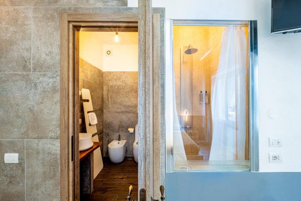 a bathroom with a shower and a toilet and a sink at My Tiny Home in Rome